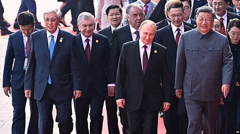 Chinese leader Xi Jinping (right) walks with foreign leaders -- including Kazakh President Qasym-Zhomart Toqaev and Uzbek President Shavkat Mirziyoyev -- at a military parade in Beijing on September 3.