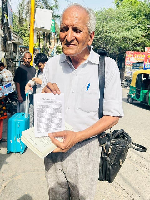 Tripathi posing with a pamphlet he wrote
