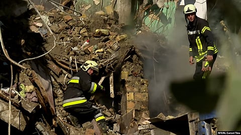 Rescue workers search the rubble of an apartment building in Kyiv after a Russian strike.