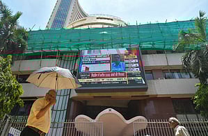 Mumbai: People walk past a screen showing stock market goes down outside BSE building at Dalal Street after the counting of votes for Lok Sabha polls, in Mumbai on Tuesday, June 4, 2024.