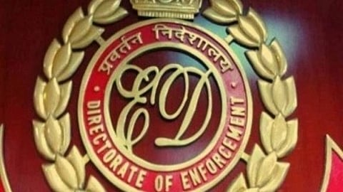 Emblem of the Directorate of Enforcement, featuring gold laurel wreaths, a crown, and bold red background conveying authority and formality.