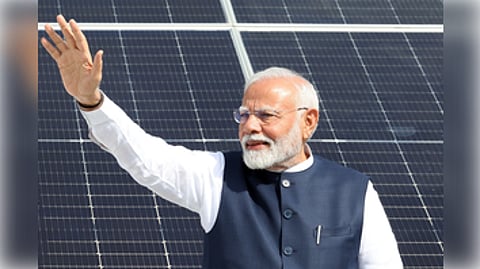 Gandhinagar: Prime Minister Narendra Modi waves to the people as he visits the residence of the beneficiaries of the PM Surya Ghar Free Electricity Yojana in Gandhinagar on Wednesday, September 18, 2024.
