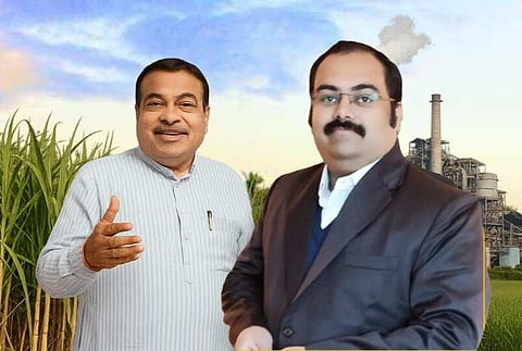 Nitin and Nikhil Gadkari standing in front of an ethanol factory