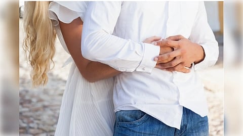 Women holding her husband from behind