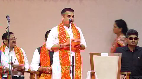 Photo of Harsh Sanghvi taking oath during the swearing-in ceremony of the newly appointed Cabinet Ministers at Mahatma Mandir in Gandhinagar