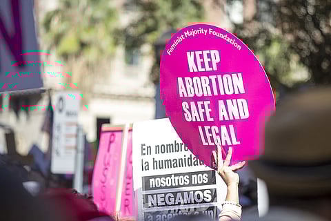 A sign reading 'keep abortion safe and legal' at a march for equality and human rights.
