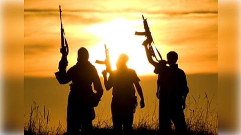 Three men holding guns stand silhouetted against a bright sun in the background.
