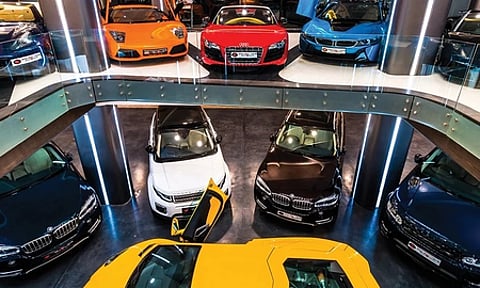 A vibrant car showroom displaying a variety of colorful sports cars arranged neatly.