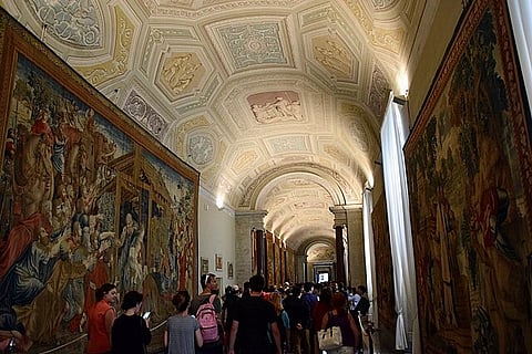 In the image visitors are shown visiting Vatican Museums, Musei Vaticani.