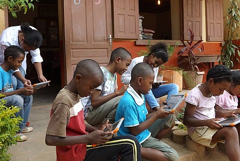 Image of multiple Children participating in the WikiChallenge Writing Contest 2017–2018.