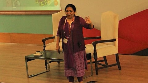 In the image prof. Madhu Kishwar is shown adressing the audience form stage