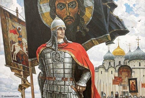 A man in steel armour is shown ready to take on any battle and behind him are flags and palaces
