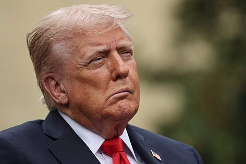 Close-up shot of Donald Trump in his blue suit and red tie.