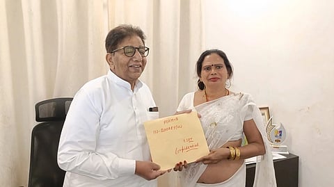 In the image Preeti Kinnar is shown taking the party ticket from the leader