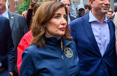 Image of governor Kathy Hochul wearing a jacket with a logo of state of new york on it.