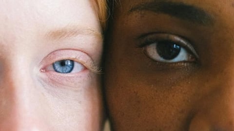 Close up shot of eyes of two different people standing close to each other.