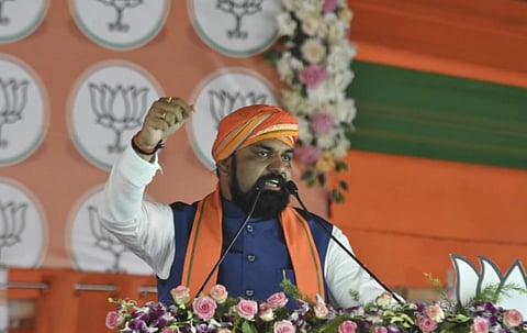 Image of Samrat Chaudhary raising his hand while giving  a speech at the grand public meeting held on the land of Pataliputra.