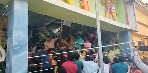 In the image the overcrowding of people is shown with many people going above through stairs