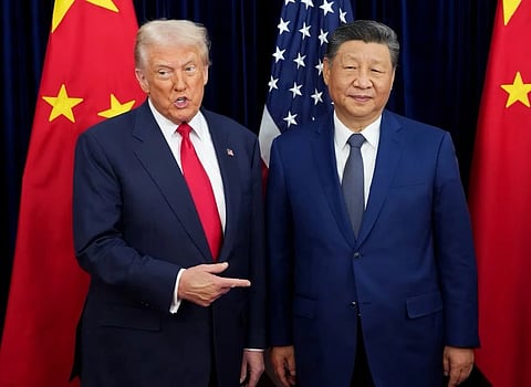 In the image US president Donald Trump and China president Xi Jingping is shown in a world summit both are wearing coats and behind them are flags of America and China