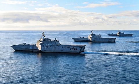 In the image Warships are shown in the ocean: The Independence variant littoral combat ships USS Tulsa (LCS 16)