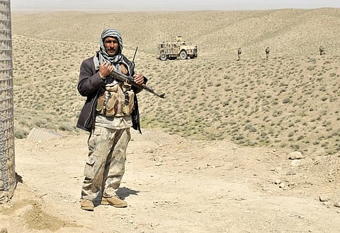 An Afghan Border Policeman secures the entrance to a new checkpoint near the Afghanistan-Pakistan border in the Spin Boldak district of Kandahar province, Afghanistan, April 1, 2013.