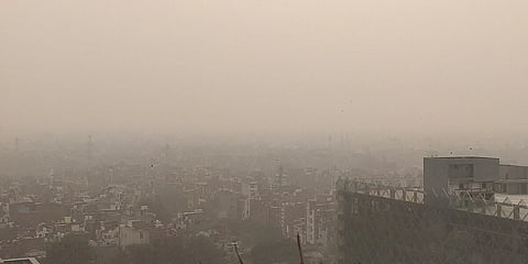 In the image the sky image of delhi is shown where there is pollution in the air and even looking at buildings is difficult