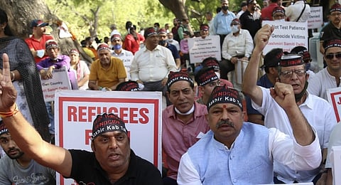 In the image manyy protesters are shown protesting for justice with posters