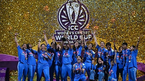 Indian Women’s Cricket Team celebrates their ICC World Cup 2025 victory after defeating South Africa in the final, with the ICC logo and confetti in the background marking the historic moment.