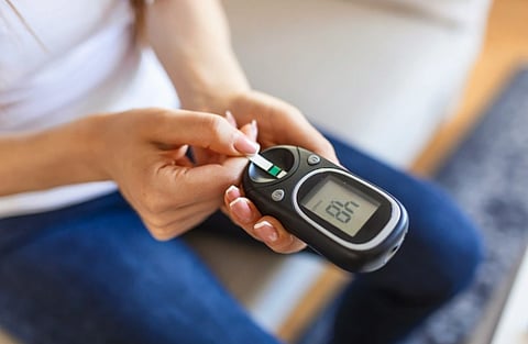 Image of a woman checking her blood sugar and metabolic health.