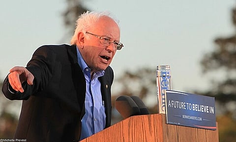 In the image Bernie Sanders is shown addressing the audience.