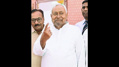 Bihar Chief Minister Nitish Kumar outside a polling station in Bakhtiyarpur, with his finger inked, after casting his vote during the first phase of the 2025 Bihar Assembly elections.