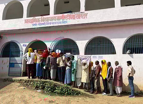 In the image voter cue is shown in front of the polling booth