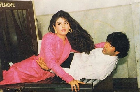 Old image of Akshay Kumar and Raveena tandon from the sets of Khiladion ka Khiladi. Raveena is seen wearing a pink dress.