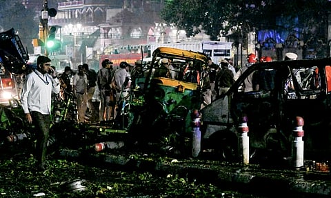 The blast tight that shows the aftermath of the explosion. The rickshaw and cars are destroyed with things scattered around as officials and forensic team investigate the site and the samples.