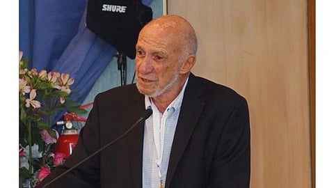 Richard A. Falk giving a speech standing in a podium at Preventing World War Through Global Solidarity: 100 Years On