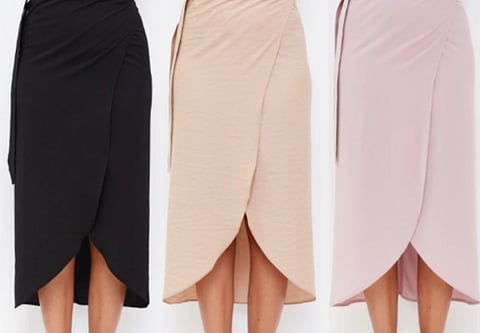 Image of Three knee-length wrap skirts in black, beige, and pink are displayed. Each skirt features a high-low hemline with a tulip shape, showcasing an elegant style.