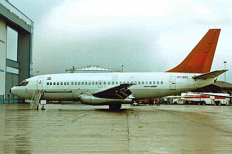 A Boeing 737-200, designated VT-EKC, in 2011, while in use by Indian Airlines. Side profile of the plane parked at an airport - it has a white body and red tail.