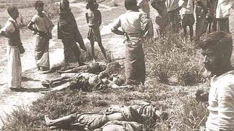 Black and white image of nellie Massacre. in the image a lot of people are standing and looking towards something. on the ground there are dead bodies laid.