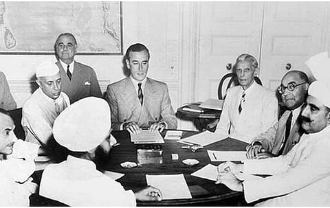 In the image Lord Mountbatten is shown meeting Nehru, Jinnah and other Leaders to plan Partition of India. The setting looks like an office and everyone is wearing formal clothes