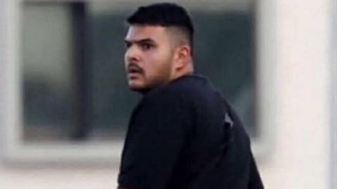 A man in black t shirt looking in the back