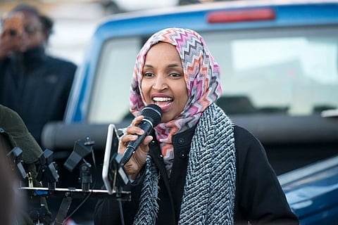 U.S. Representative Ilhan Omar is speaking in a mic, addressing people.