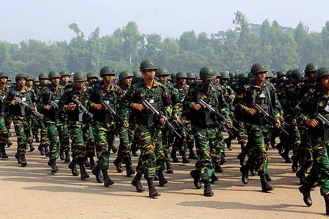 The photo depicts soldiers marching in a parade. It is of the Victory Day parade of Bangladesh in 2011.