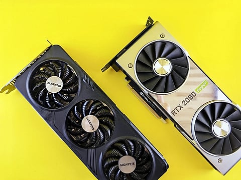 Two GPUs (RTX 2080 Super) lying on a yellow background at an angle.