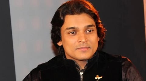 Image of Men's right activist Rahul Easwar wearing a black jacket. the background is semi lit.