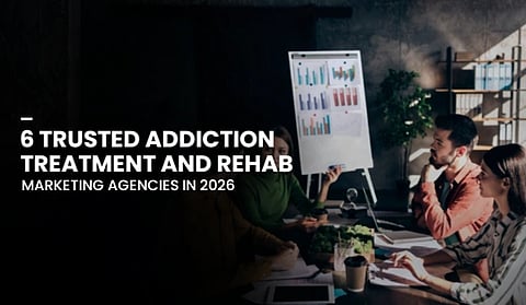 Group of professionals in a meeting, discussing near a chart with bar graphs. Text overlay reads "6 Trusted Addiction Treatment and Rehab Marketing Agencies in 2026."