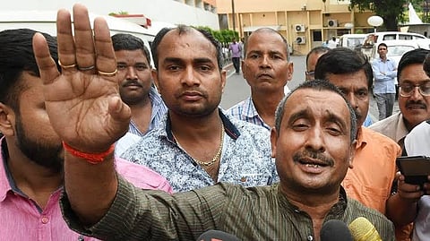 The photo depicts convicted ex BJP MLA Kuldeep Singh Sengar, addressing media with a group of people behind him.