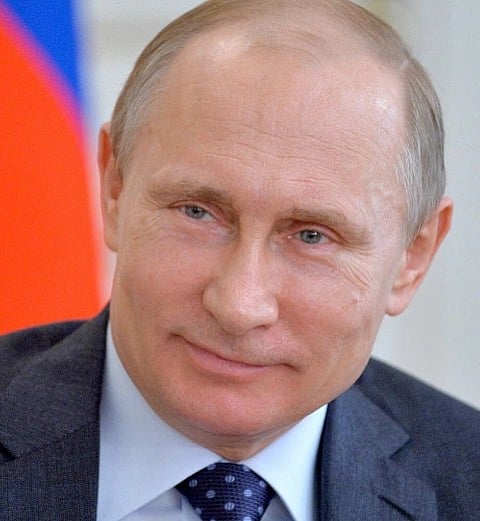 Image of Vladimir Putin
President of Russia
smiling into the camera. he wearing a grey suit with polka dotted tie.