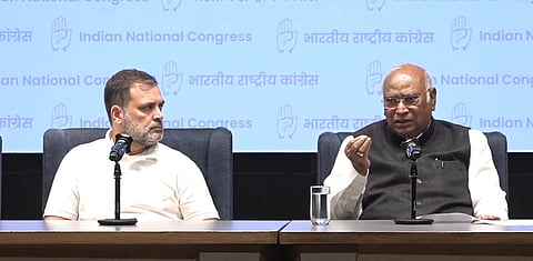 The image shows Rahul Gandhi and Mallikarjun Kharge in a press brief.