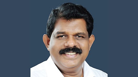 In the image Antony Raju is shown wearing white shirt he is smiling in the camera the background is blank