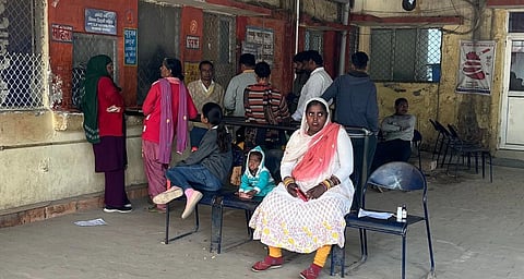 People waiting in front of counters at a clinic in Bhiwadi.
